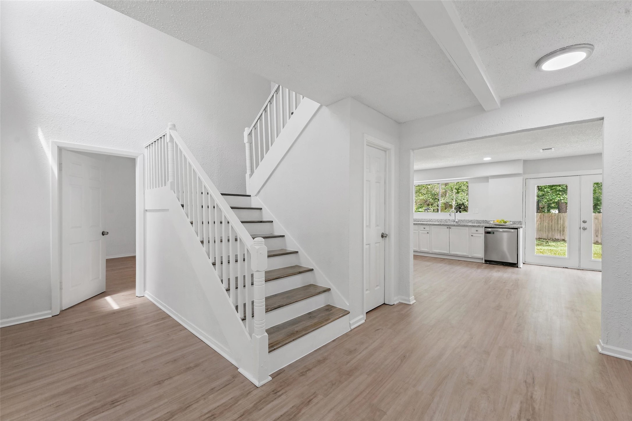 18009 Split Oak Circle New Caney, TX 77357 - Photo 12 of 30 a view of a hallway with wooden floor and stairs