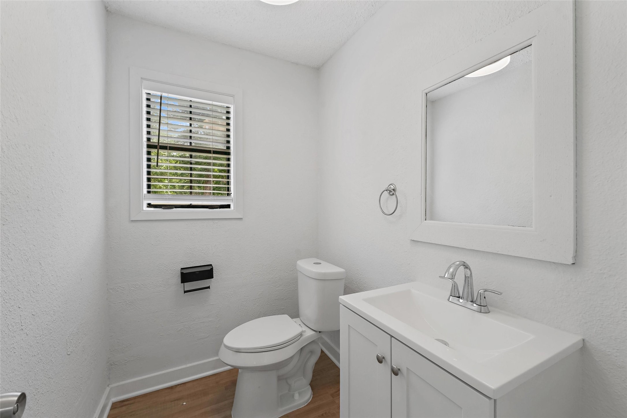 18009 Split Oak Circle New Caney, TX 77357 - Photo 13 of 30 a bathroom with a toilet sink vanity and mirror