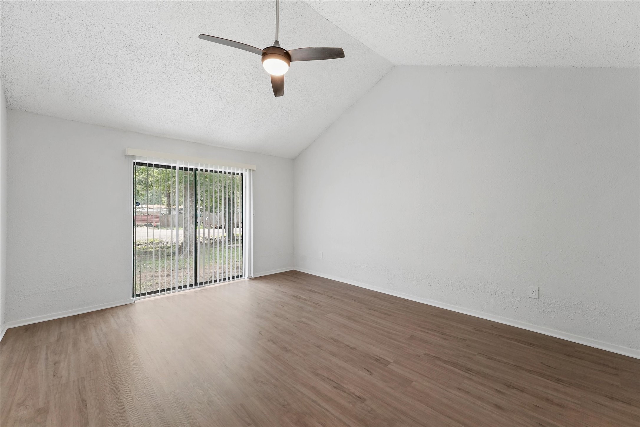 18009 Split Oak Circle New Caney, TX 77357 - Photo 14 of 30 an empty room with wooden floor and windows