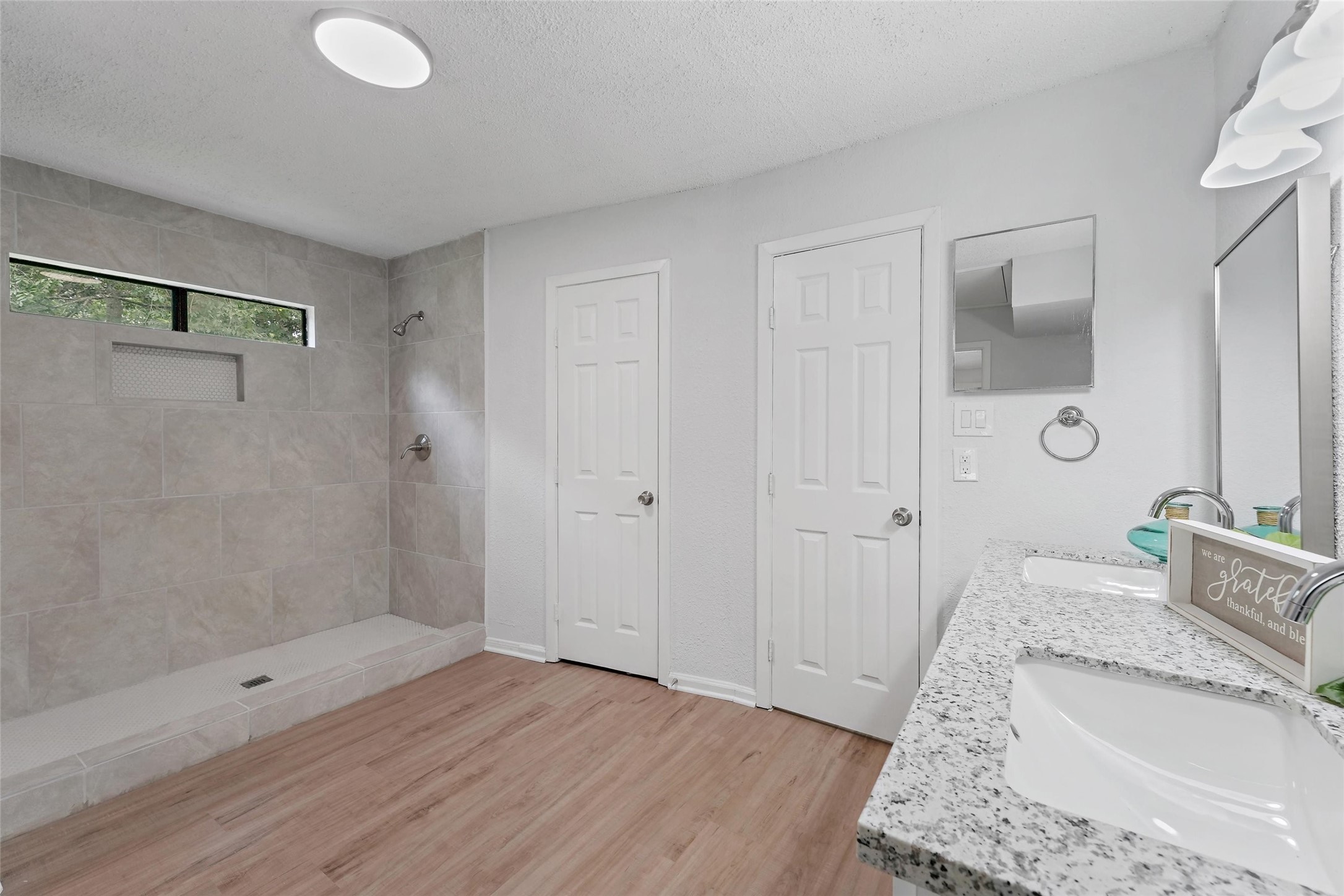 18009 Split Oak Circle New Caney, TX 77357 - Photo 15 of 30 a bathroom with a granite countertop sink a toilet and shower