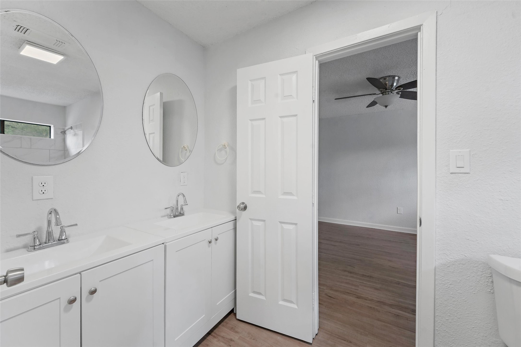 18009 Split Oak Circle New Caney, TX 77357 - Photo 20 of 30 a bathroom with a double vanity sink and mirror