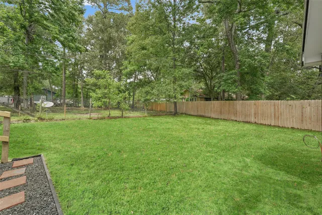a view of outdoor space with deck and yard