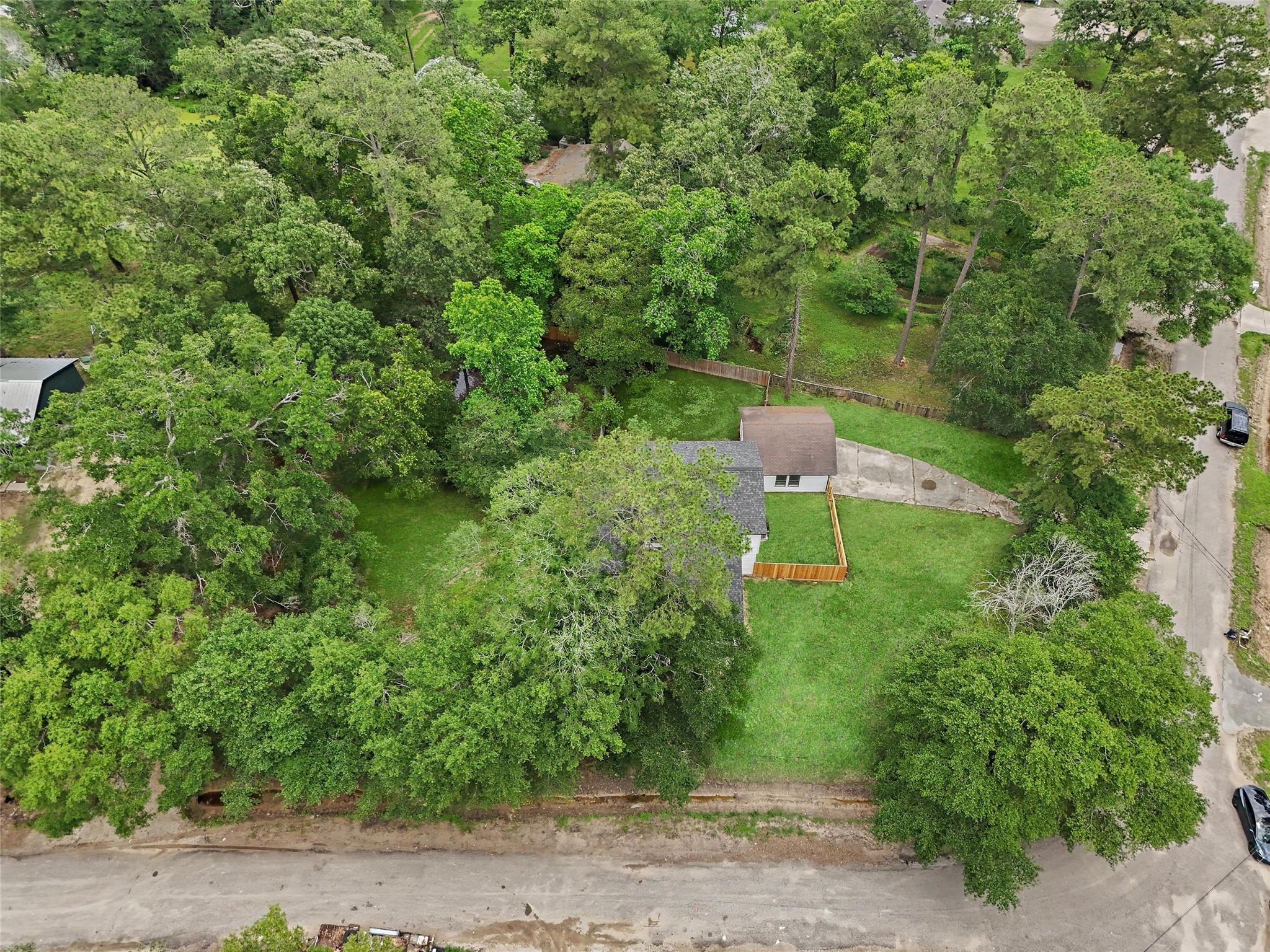18009 Split Oak Circle New Caney, TX 77357 - Photo 29 of 30 a backyard of a house with a lots of plants and trees