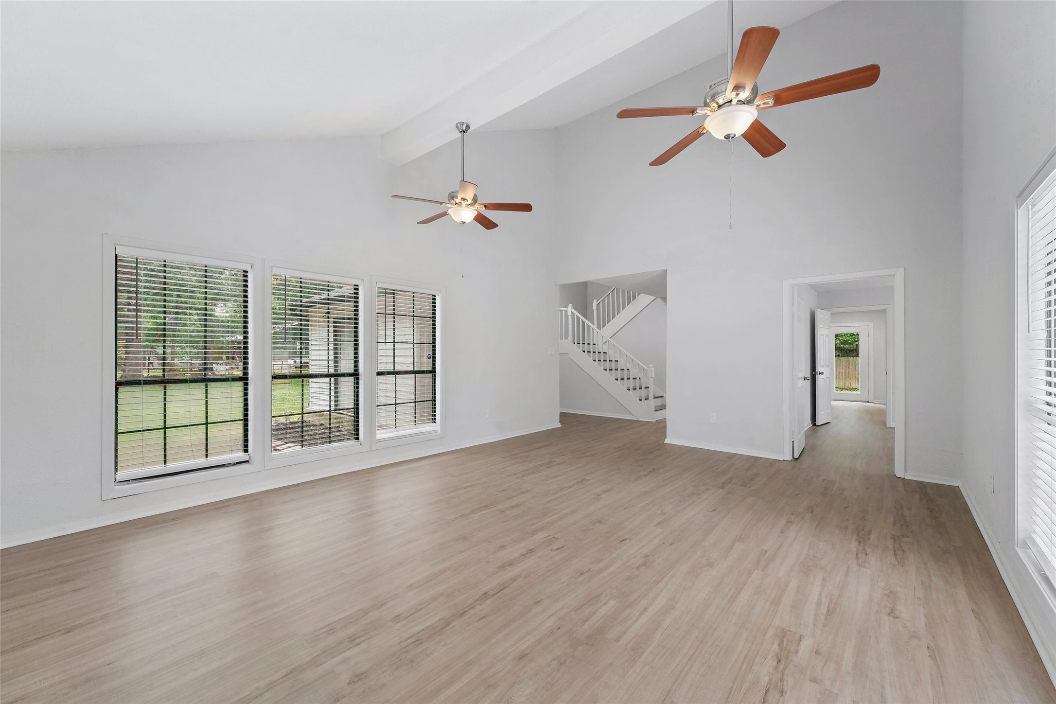 18009 Split Oak Circle New Caney, TX 77357 - Photo 6 of 30 an empty room with wooden floor fan and windows