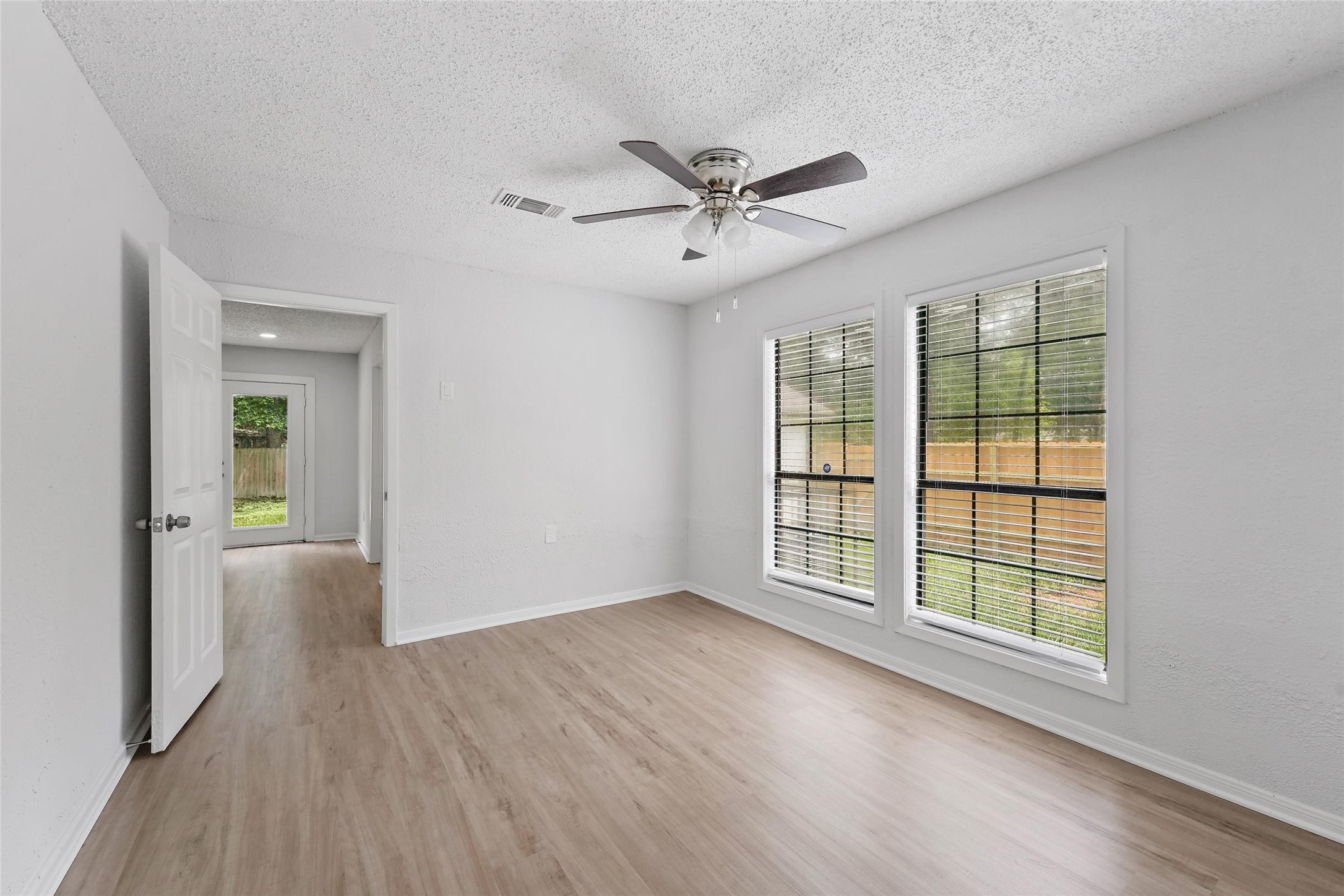 18009 Split Oak Circle New Caney, TX 77357 - Photo 7 of 30 a view of an empty room with a window and wooden floor