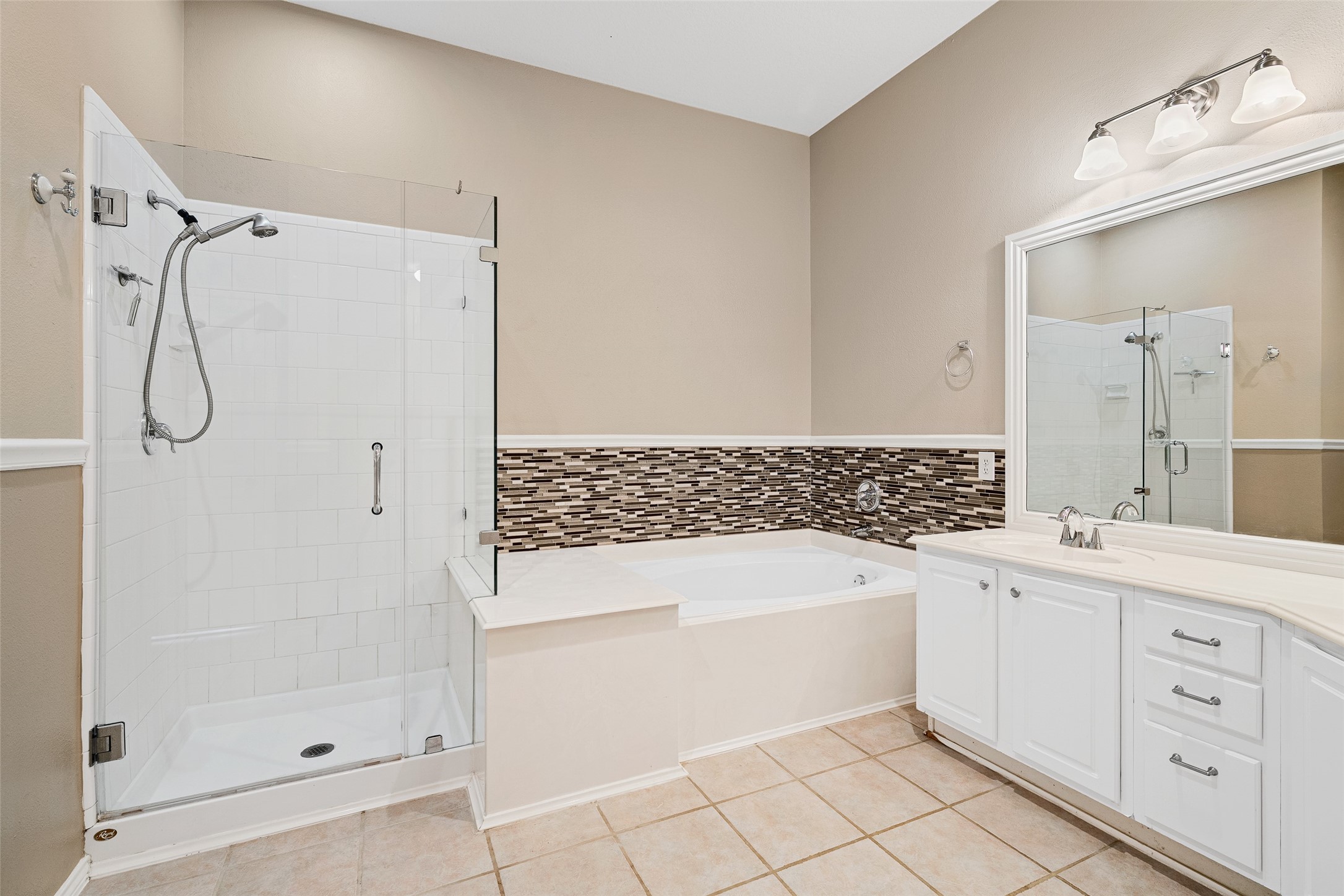 2218 Louetta Brook Lane Spring, TX 77388 - Photo 8 of 18 a bathroom with a bathtub sink and mirror
