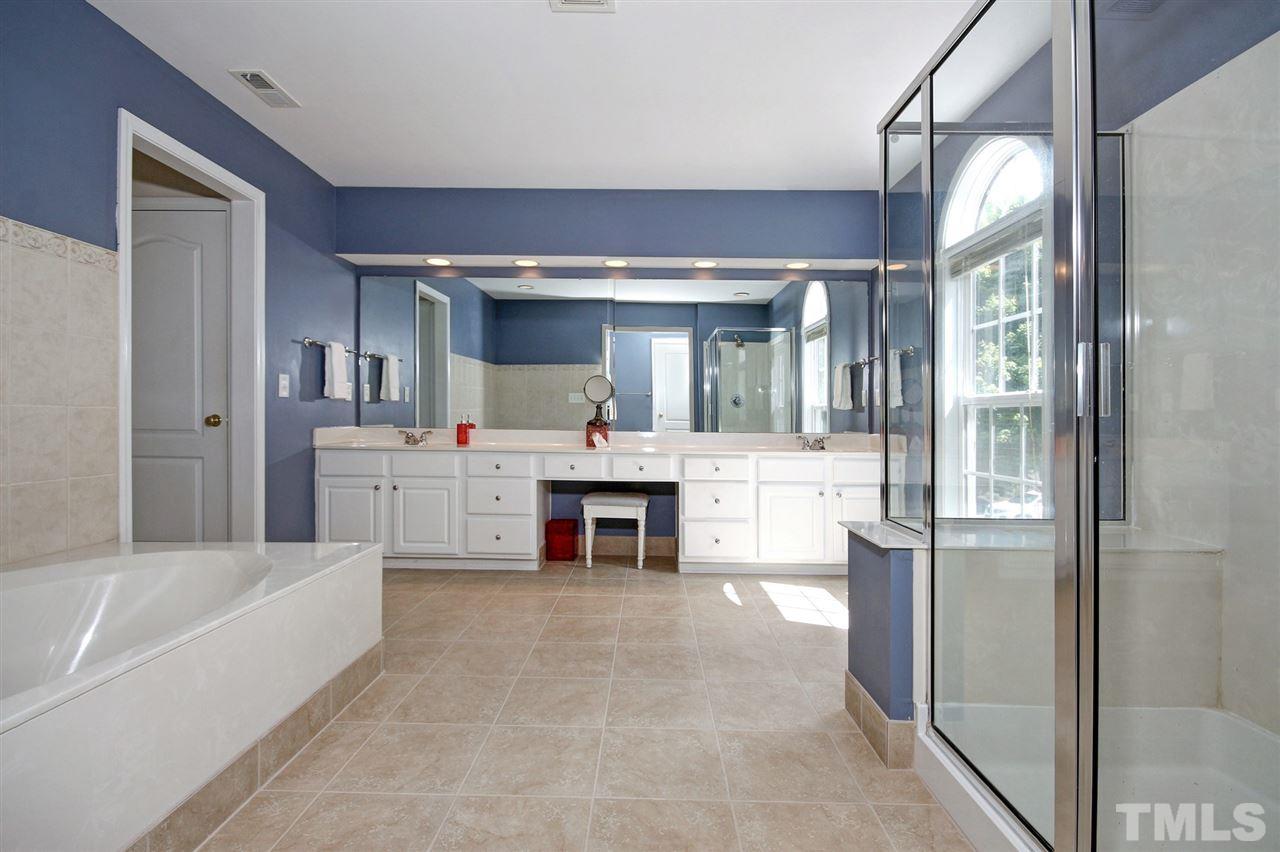 7532 Silver View Lane Raleigh, NC 27613 - Photo 16 of 30 HUGE owner's suite with very big his and her closets, so much counter space, storage, dual vanities, tile surround soaker tub and stand alone shower.