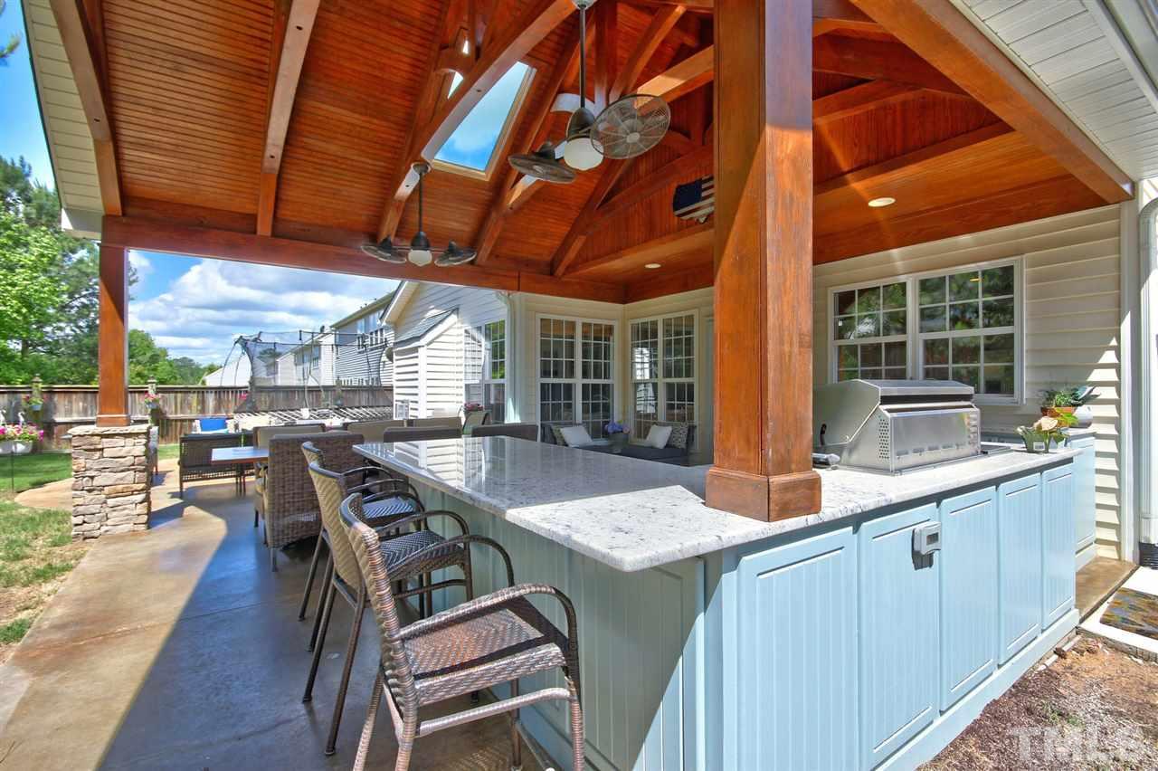 7532 Silver View Lane Raleigh, NC 27613 - Photo 26 of 30 Additional view of the custom outdoor kitchen with plenty of yard space left for a trampoline and surrounded by a privacy fence.