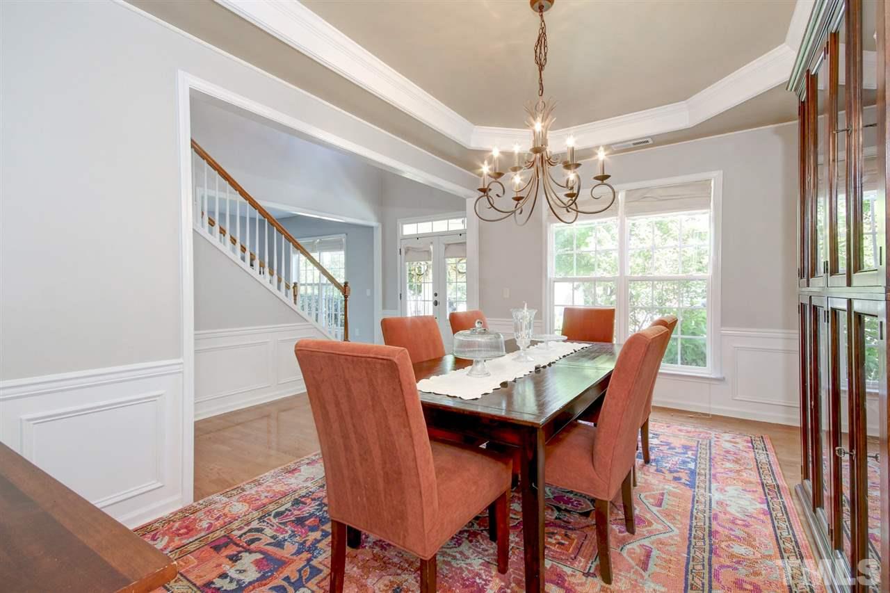7532 Silver View Lane Raleigh, NC 27613 - Photo 4 of 30 Elegant dining room with ample natural lighting. Hardwoods floors , wainscoting and tray ceiling. Host a formal dinner party with friends and family or a casual buffet style dinner. Room for everyone!