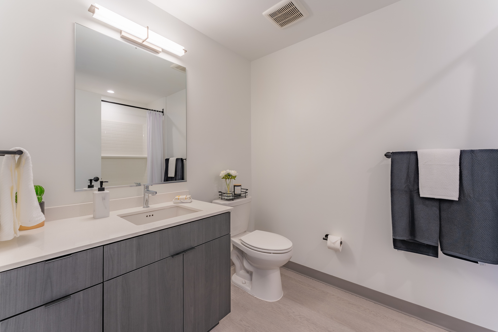 Undisclosed Address Chicago, IL 60642 - Photo 13 of 15 a bathroom with a toilet sink and mirror