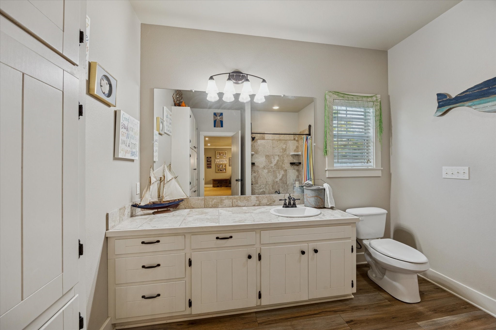 2510 Round Top Road Round Top, TX 78954 - Photo 12 of 20 a bathroom with a double vanity sink mirror and toilet