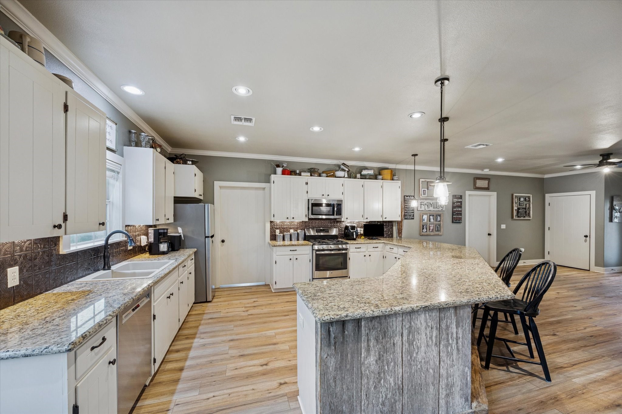 2510 Round Top Road Round Top, TX 78954 - Photo 4 of 20 a kitchen with stainless steel appliances granite countertop a stove oven and a sink