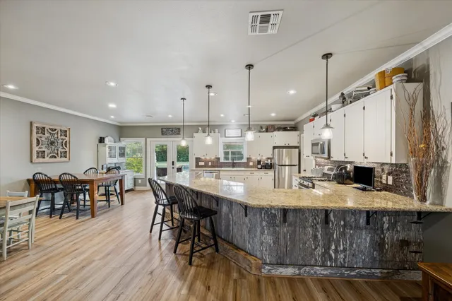a large kitchen with a table and chairs