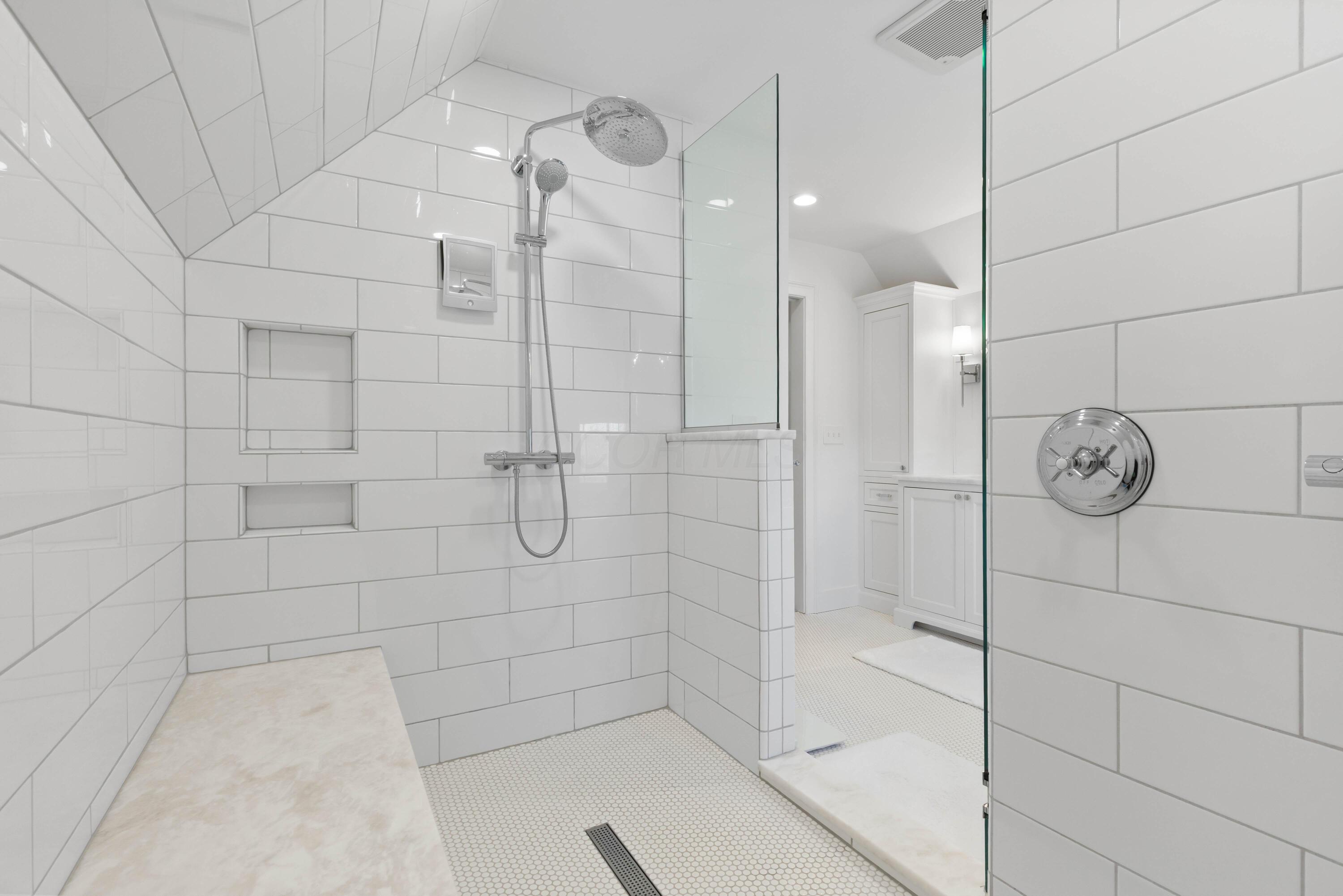 1364 Dale Ford Road Delaware, OH 43015 - Photo 55 of 112 • Ceramic tile flooring • White painted walls • Custom built enclosed vanity with double bowl, marble sinktop • Lighted wall sconces • Bubble jetted garden tub • Linen storage • Chandelier • Can lighting • (2) shower stations with rainhead & wands with ceramic tile surround • (1) extra rainhead in center with ceramic tile surround • Pocket door • Mirrors are negotiable