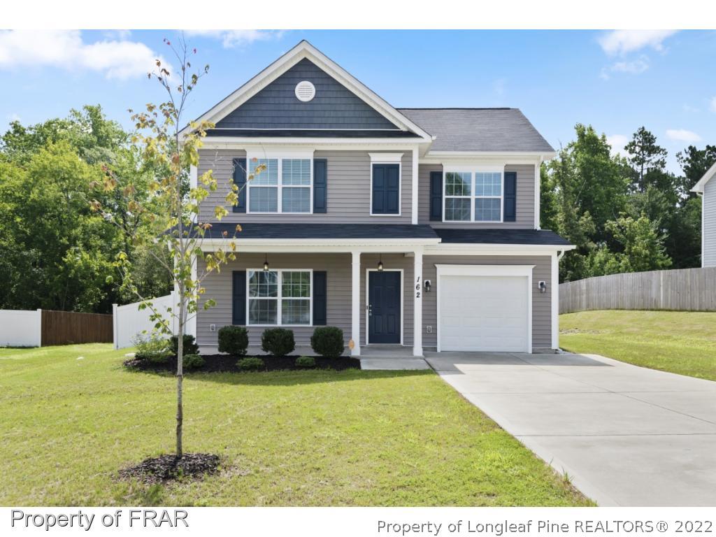 162 Watchmen Lane Cameron, NC 28326 - Photo 1 of 23 a front view of a house with a yard