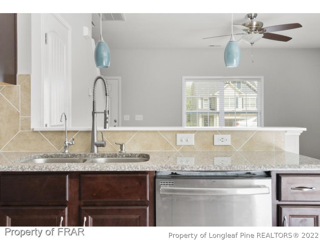 162 Watchmen Lane Cameron, NC 28326 - Photo 4 of 23 a kitchen with granite countertop a sink stainless steel appliances and cabinets