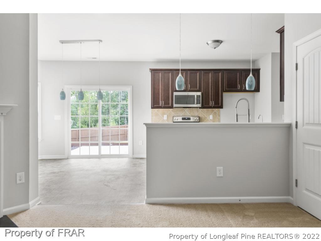 162 Watchmen Lane Cameron, NC 28326 - Photo 7 of 23 a kitchen view with wooden floor a sink and a counter top space