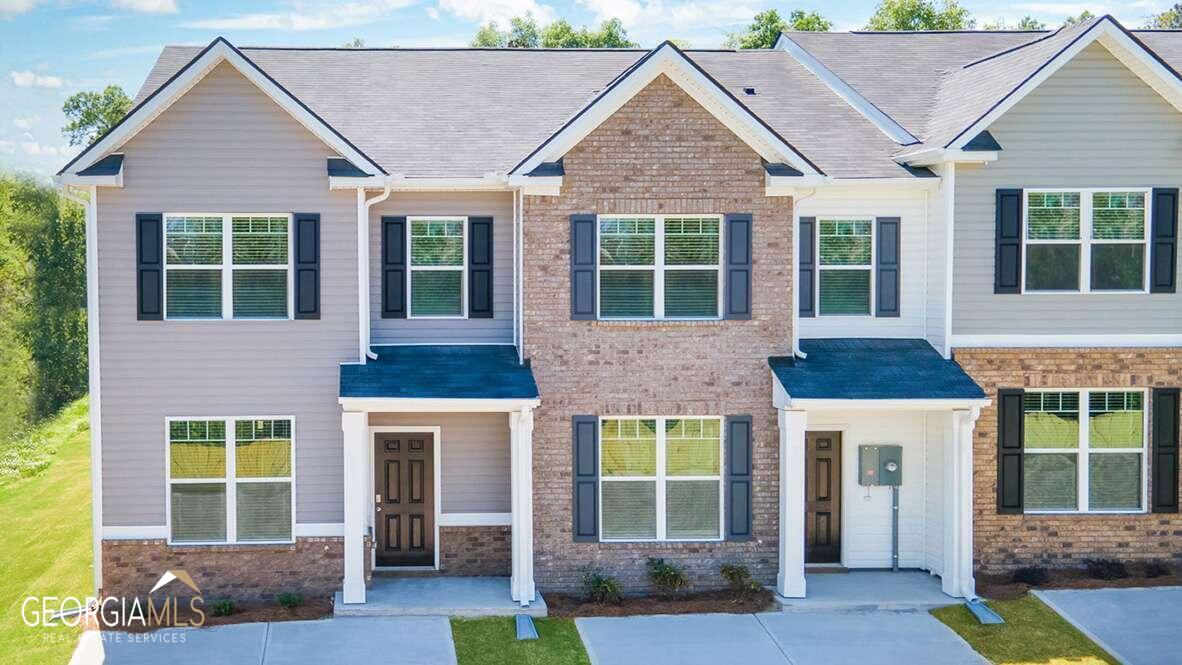 4291 Arcadia Drive, Unit 8 Decatur, GA 30034 - Photo 1 of 1 a front view of a house with a yard and potted plants