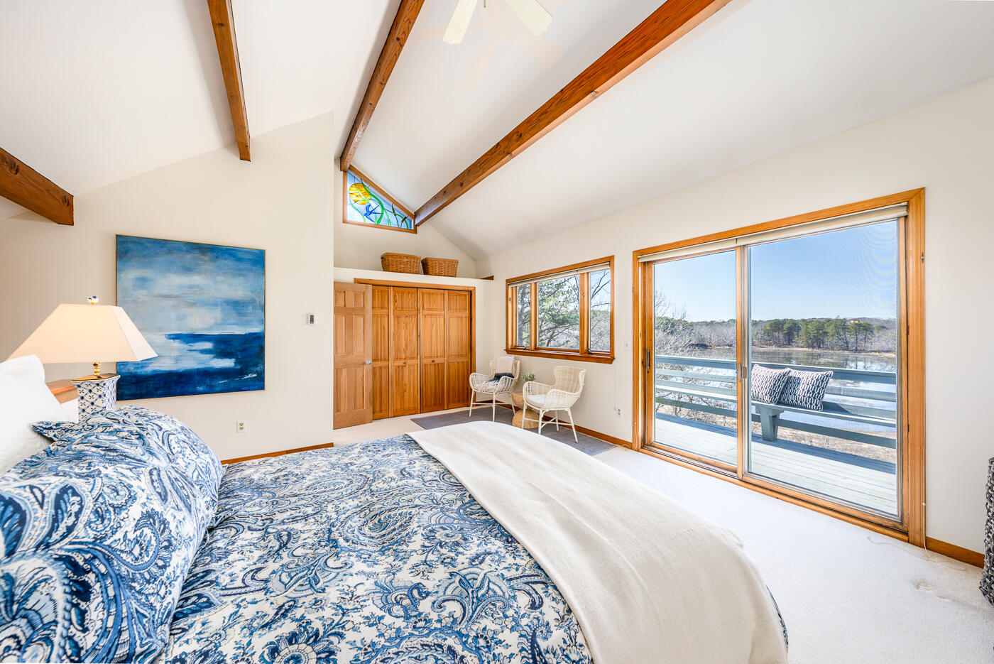 210 Lieutenant Island Road Wellfleet, MA 02667 - Photo 19 of 47 a bedroom with a large bed and a large window