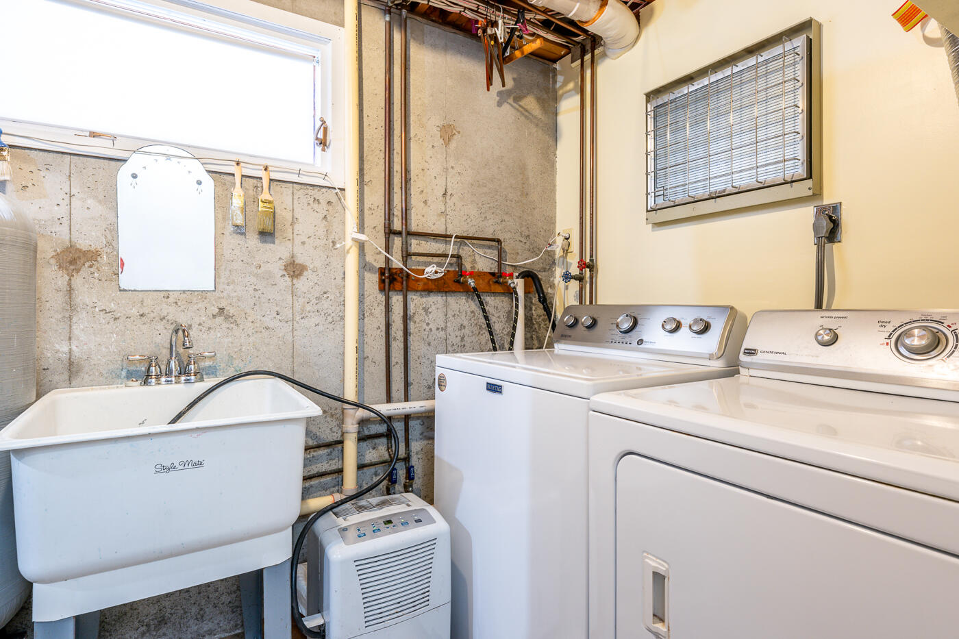 210 Lieutenant Island Road Wellfleet, MA 02667 - Photo 34 of 47 a bathroom with a sink and a washing machine with a mirror