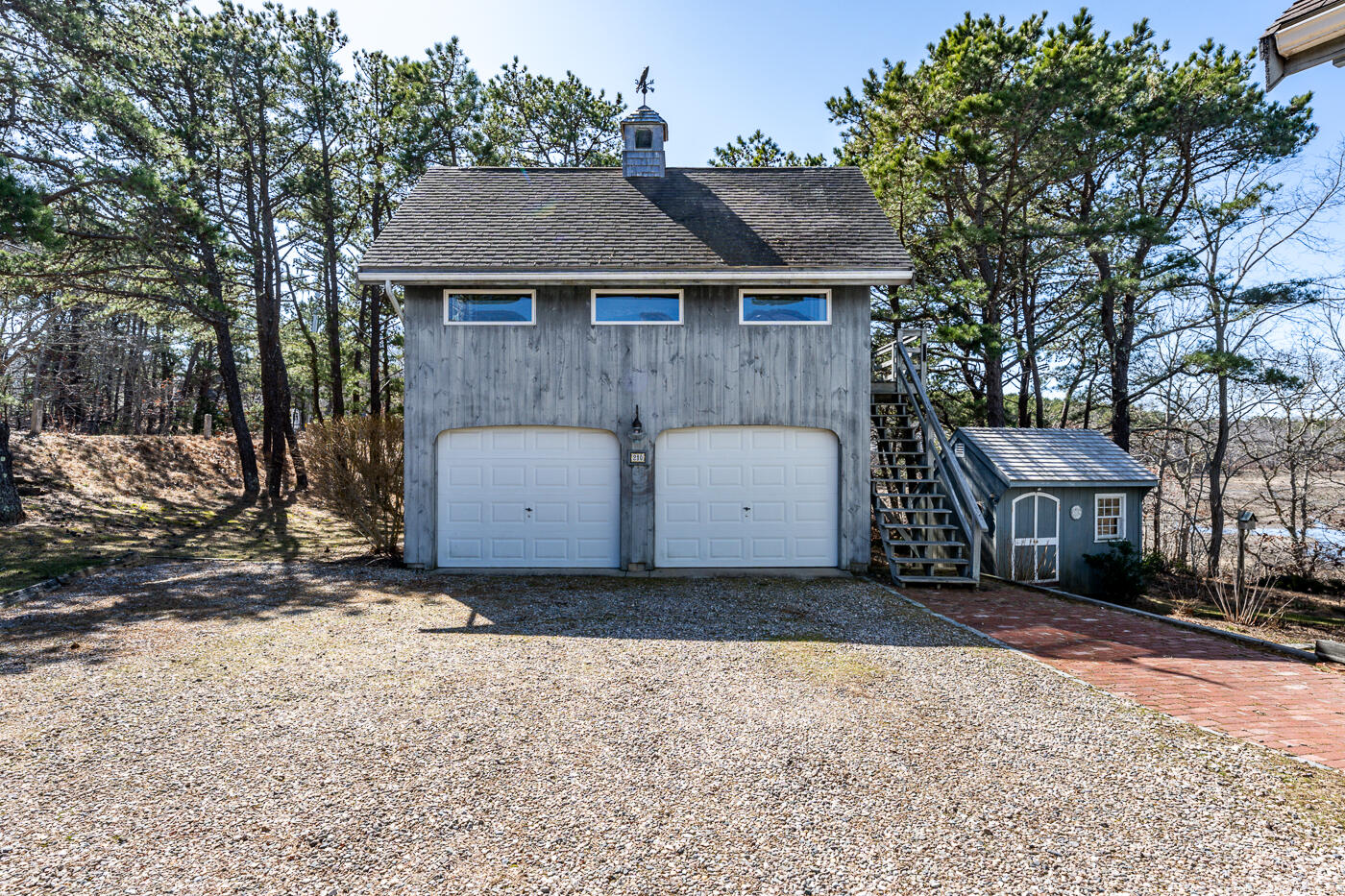 210 Lieutenant Island Road Wellfleet, MA 02667 - Photo 38 of 47 a front view of a house with a yard and garage