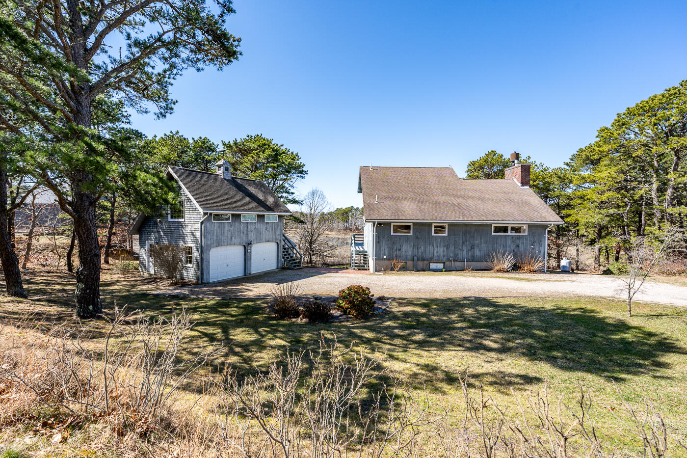 210 Lieutenant Island Road Wellfleet, MA 02667 - Photo 43 of 47 a tall house with a large tree in front of it