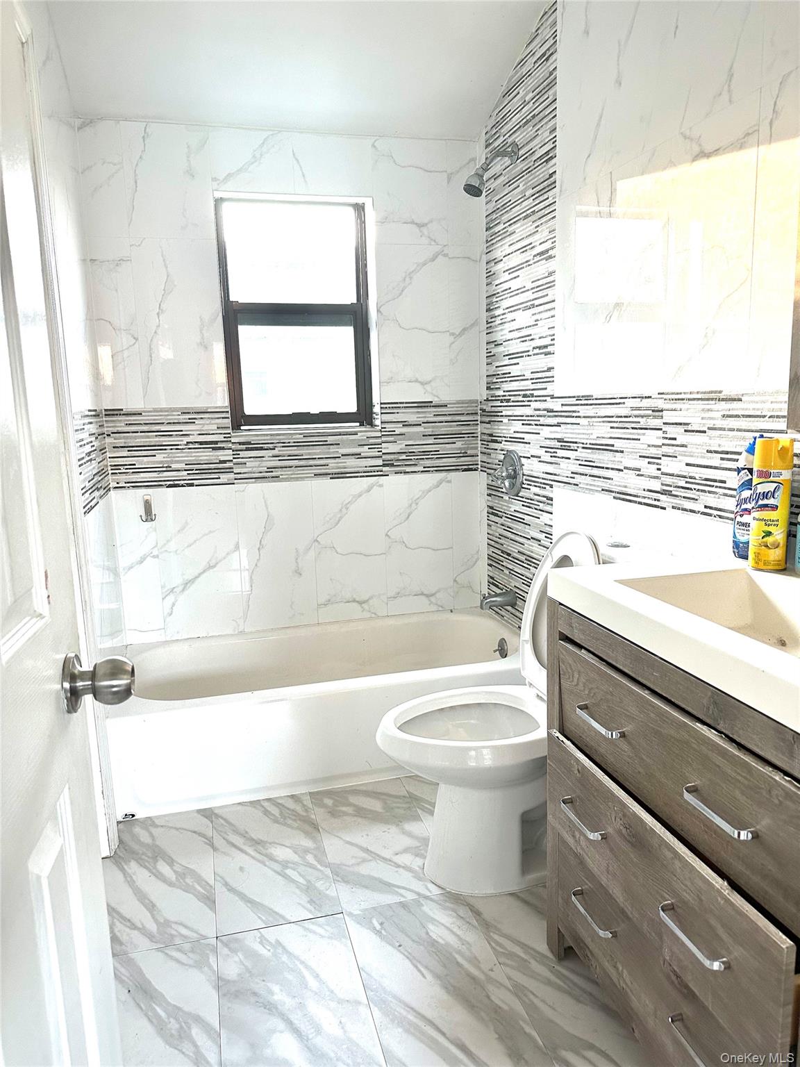 235-18 147th Road Queens, NY 11422 - Photo 4 of 5 a bathroom with a toilet a sink and a bathtub