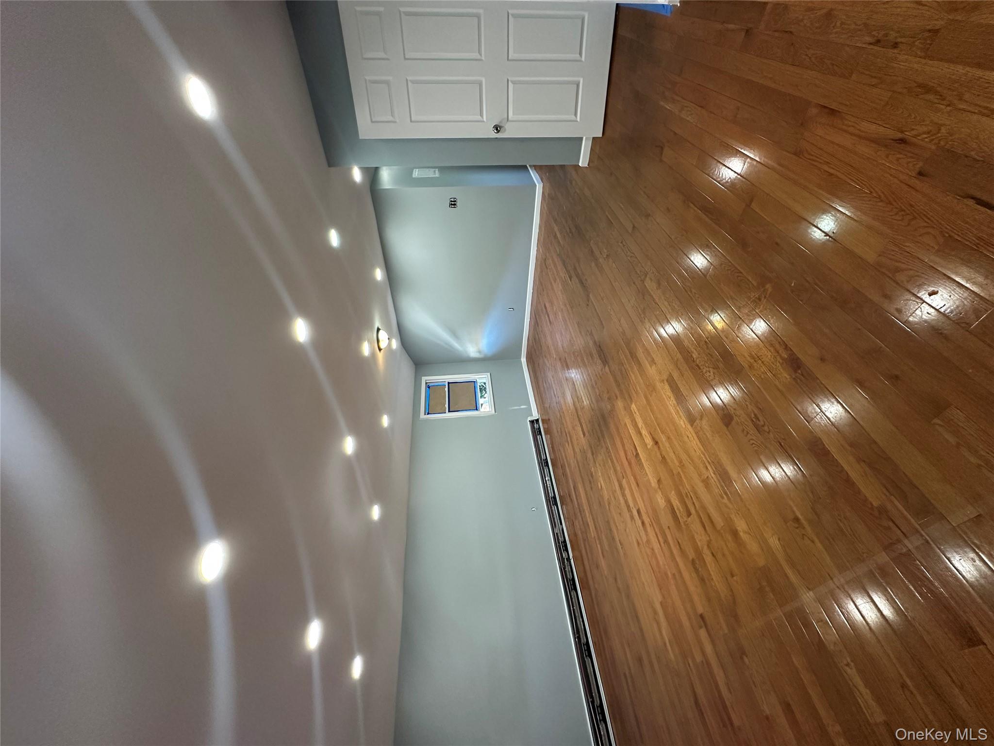 235-18 147th Road Queens, NY 11422 - Photo 5 of 5 a view of an empty room with wooden floor