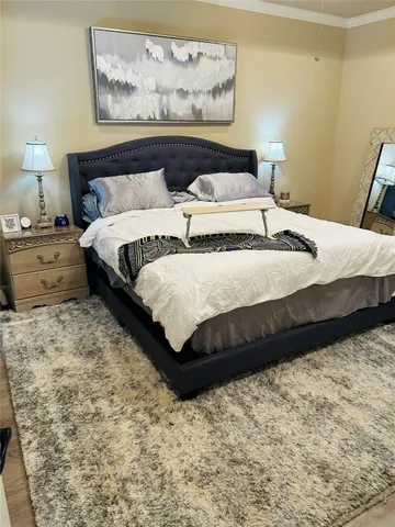 a bedroom with bed and painting on the wall