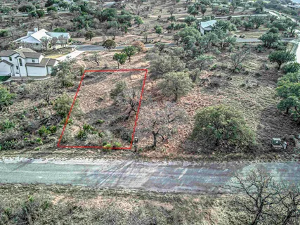 a view of a wooden bridge with flowers