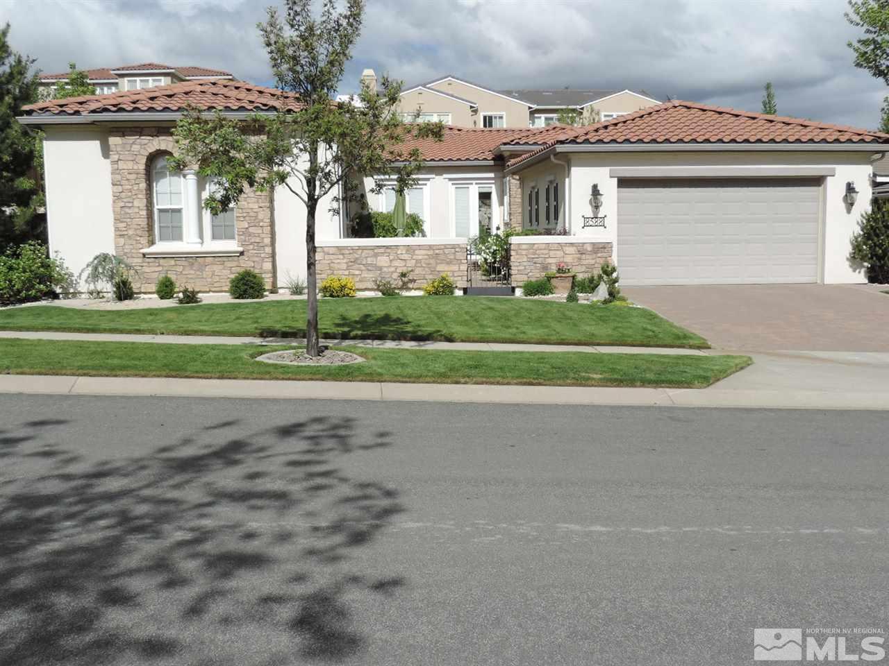 8588 Timaru Trail Reno, NV 89523 - Photo 1 of 25 a front view of a house with a garden and garage