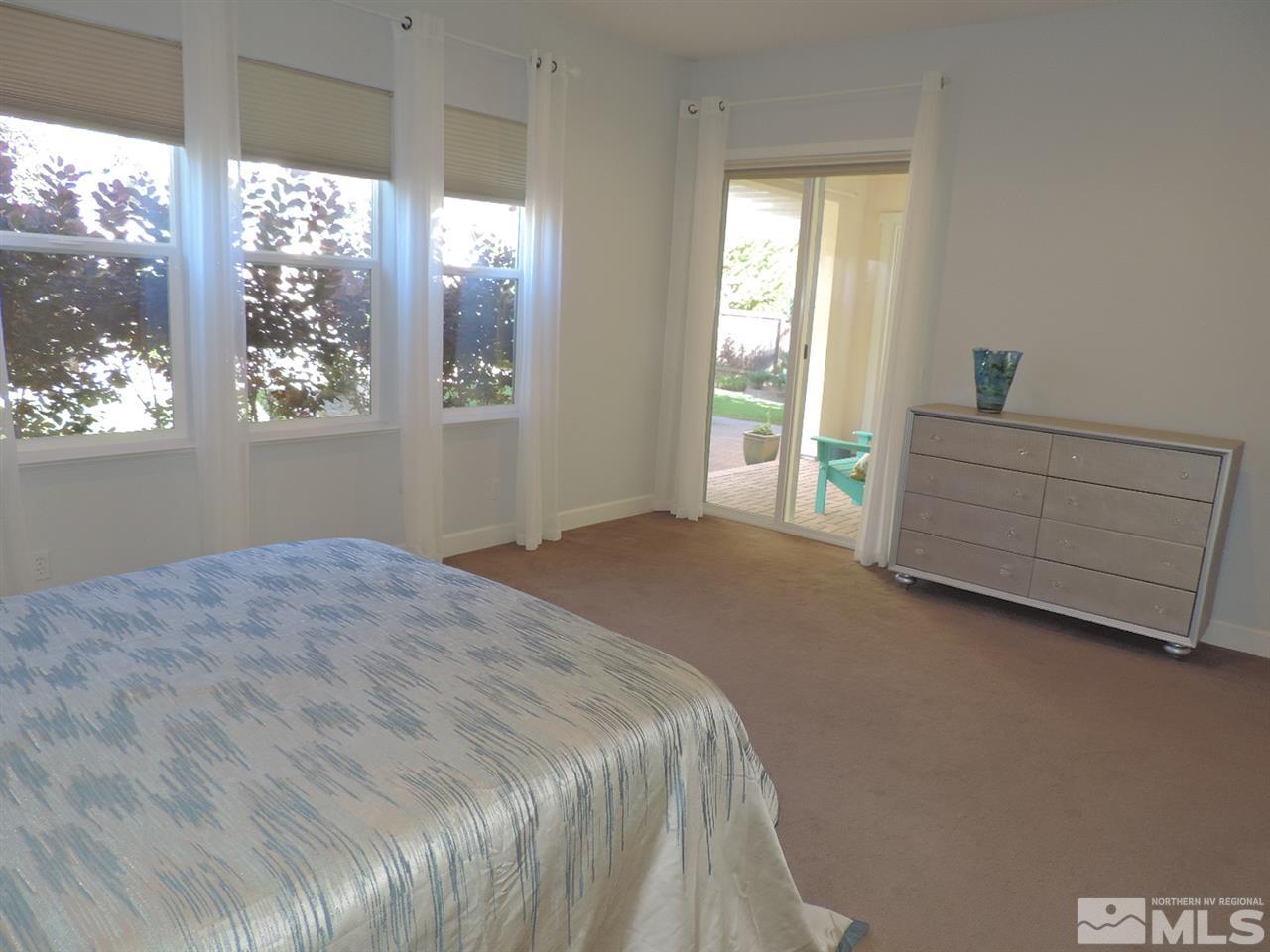 8588 Timaru Trail Reno, NV 89523 - Photo 14 of 25 a bedroom with a bed and a window