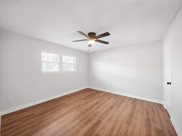 a bathroom with a granite countertop sink toilet and mirror