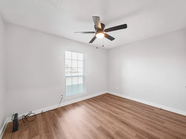 a kitchen with granite countertop white cabinets and stainless steel appliances