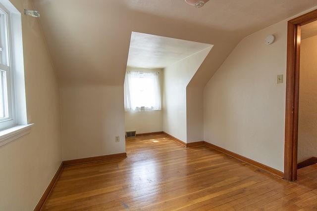935 Howden Street Pittsburgh, PA 15202 - Photo 11 of 16 an empty room with wooden floor and windows