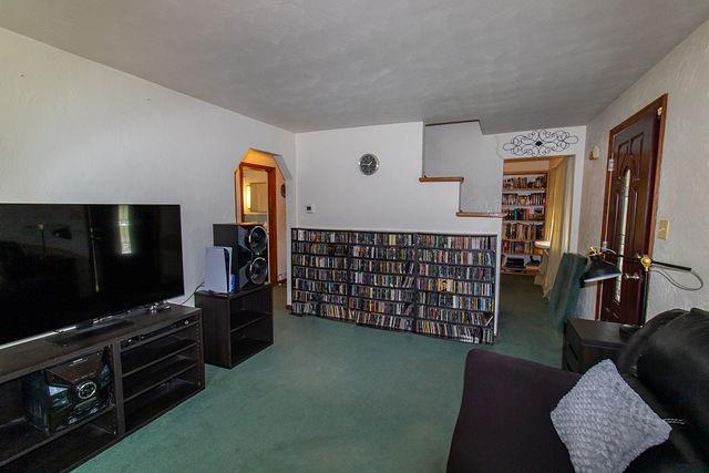 935 Howden Street Pittsburgh, PA 15202 - Photo 3 of 16 a living room with furniture a flat screen tv and a refrigerator
