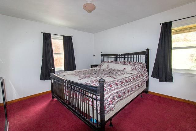 935 Howden Street Pittsburgh, PA 15202 - Photo 4 of 16 a bed sitting in a bedroom next to a window