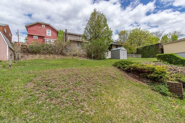 935 Howden Street Pittsburgh, PA 15202 - Photo 6 of 16 a front view of a house with a yard and garage