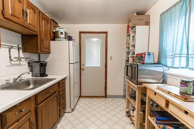 935 Howden Street Pittsburgh, PA 15202 - Photo 8 of 16 a kitchen with stainless steel appliances a sink and a refrigerator