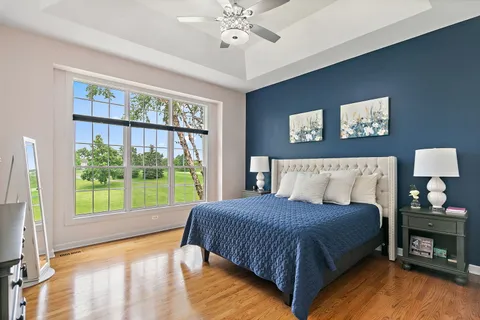 a bedroom with a large bed and a large window