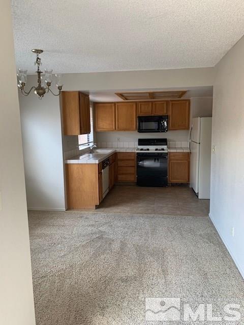 1775 Amarak Way Reno, NV 89523 - Photo 3 of 17 a kitchen with granite countertop a refrigerator and a stove