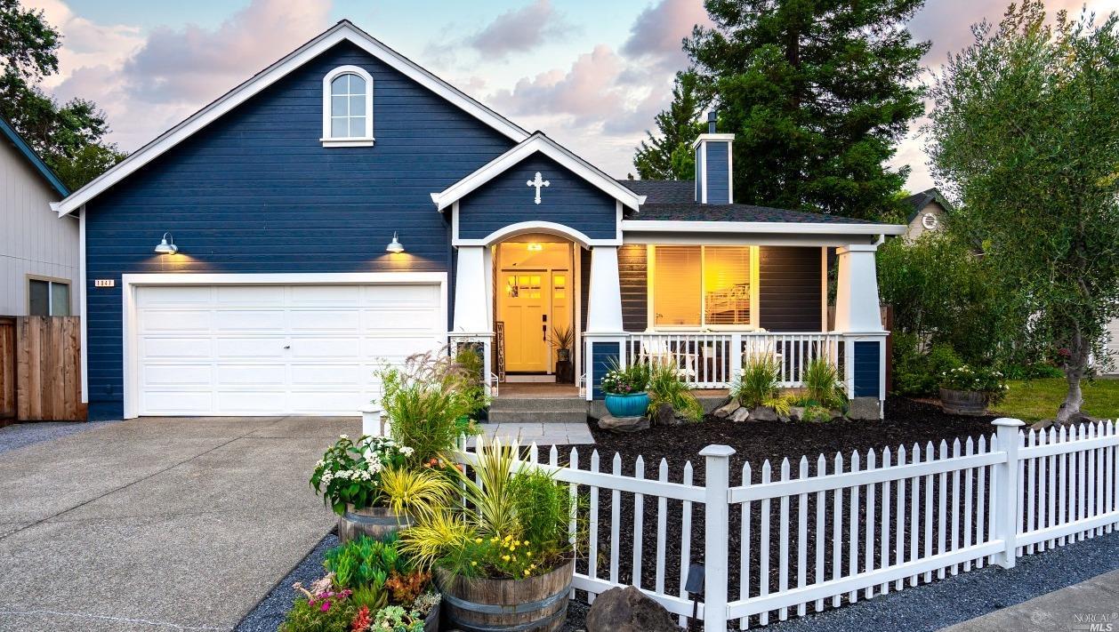 a front view of house along with deck and yard