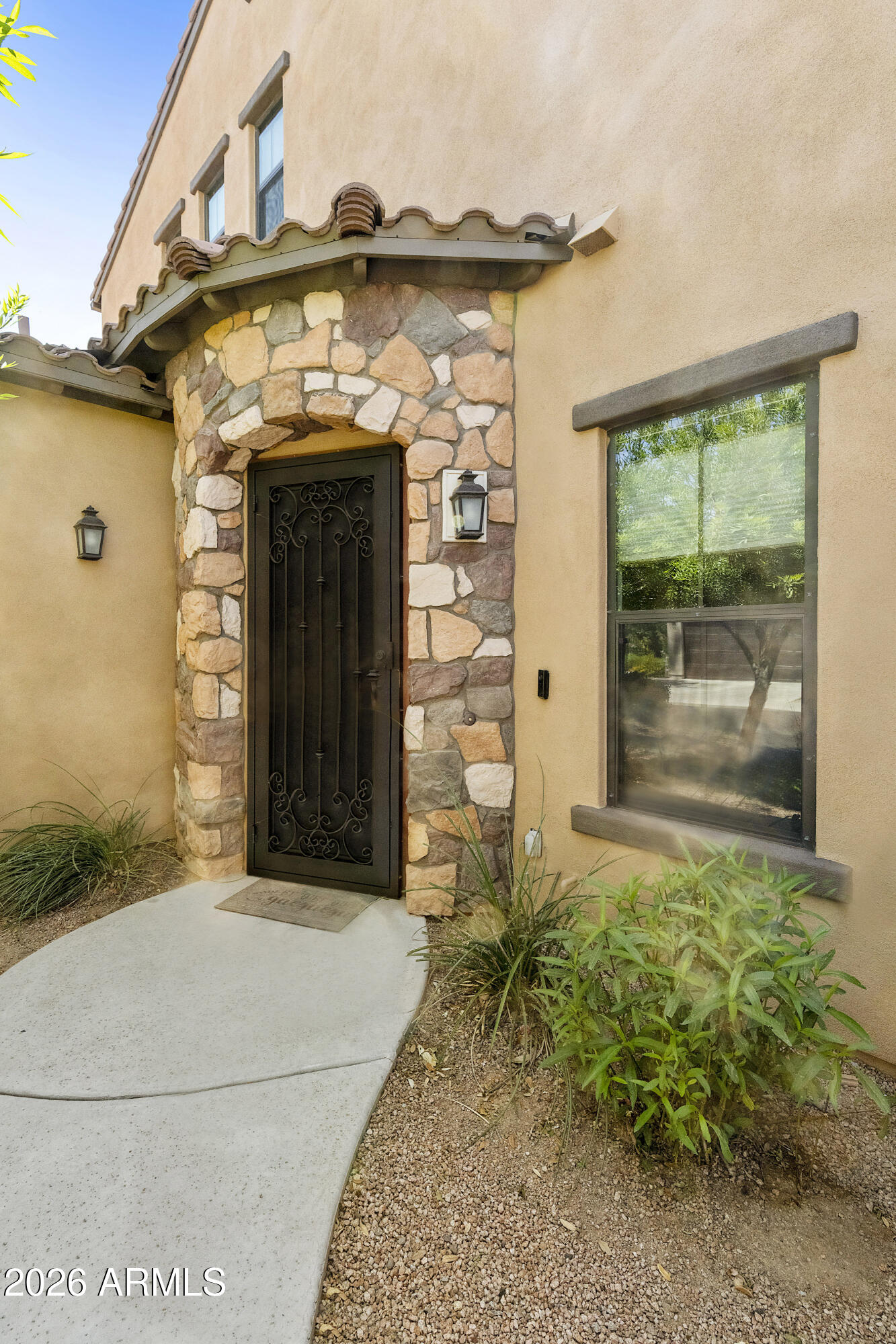 4777 South Fulton Ranch Boulevard, Unit 1123 Chandler, AZ 85248 - Photo 13 of 18 a front view of a house with garden
