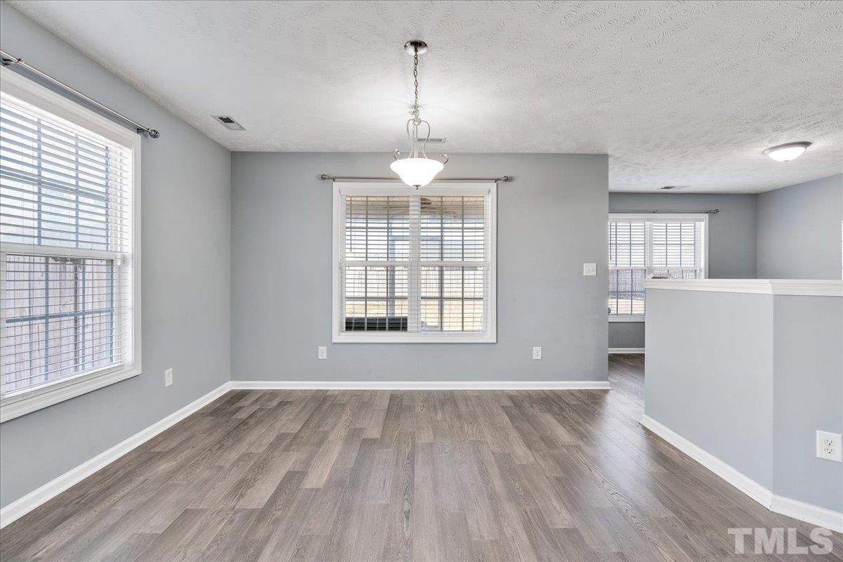 549 Cape Fear Road Raeford, NC 28376 - Photo 12 of 27 a view of a room with wooden floor exposed radiator and windows