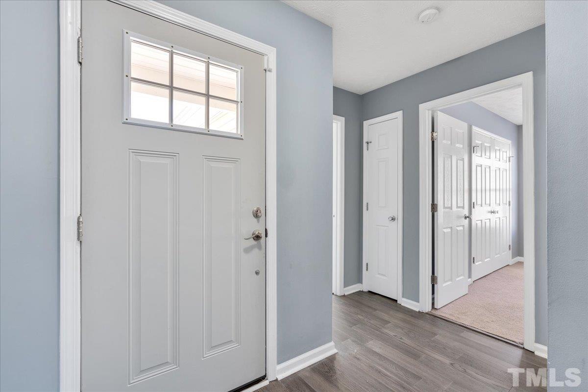 549 Cape Fear Road Raeford, NC 28376 - Photo 3 of 27 an empty room with wooden floor and windows