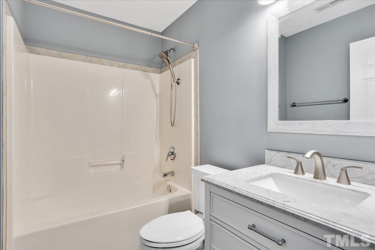 549 Cape Fear Road Raeford, NC 28376 - Photo 4 of 27 a bathroom with a granite countertop sink toilet and shower