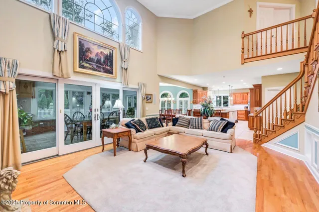 a dining room with furniture a chandelier and wooden floor
