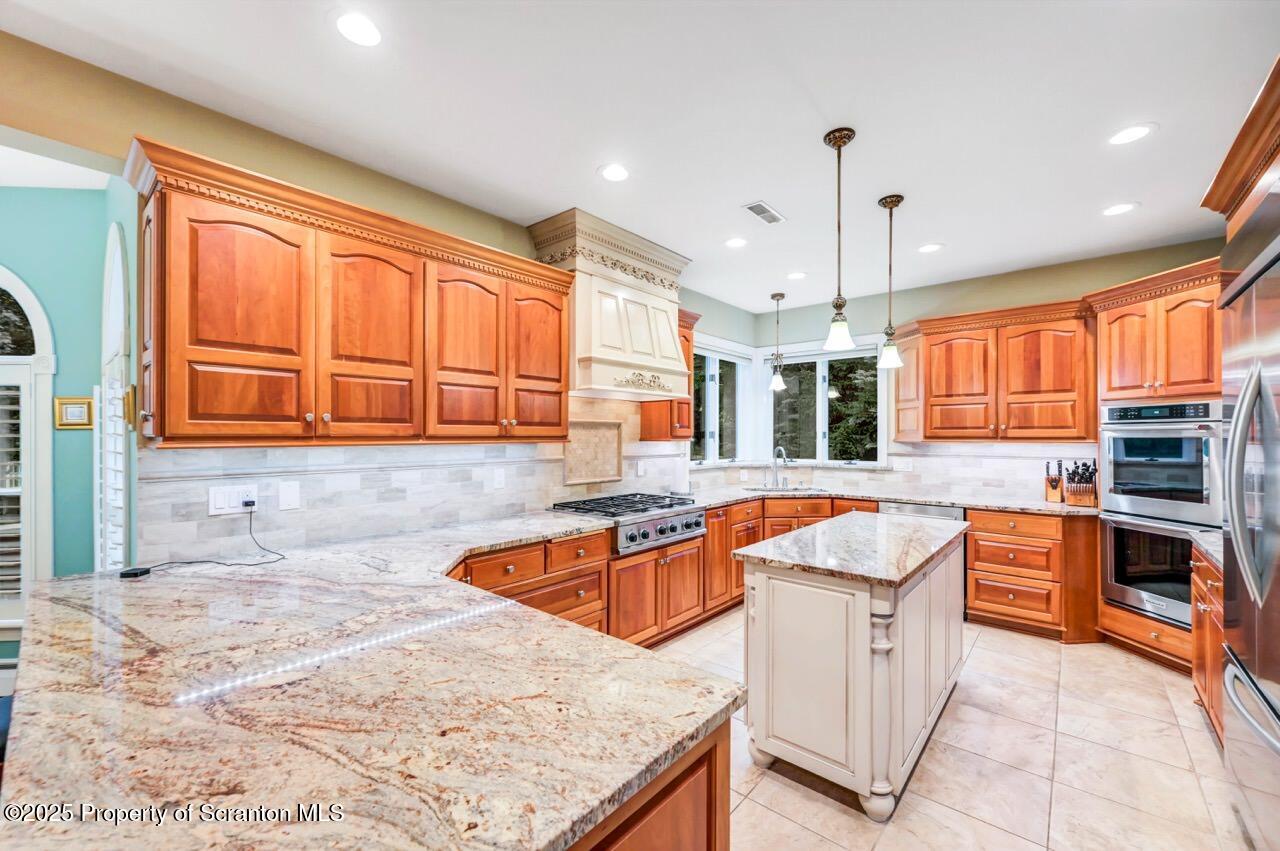 922 Old Logger Road Moscow, PA 18444 - Photo 23 of 93 a kitchen with stainless steel appliances granite countertop a sink a stove and a wooden floors