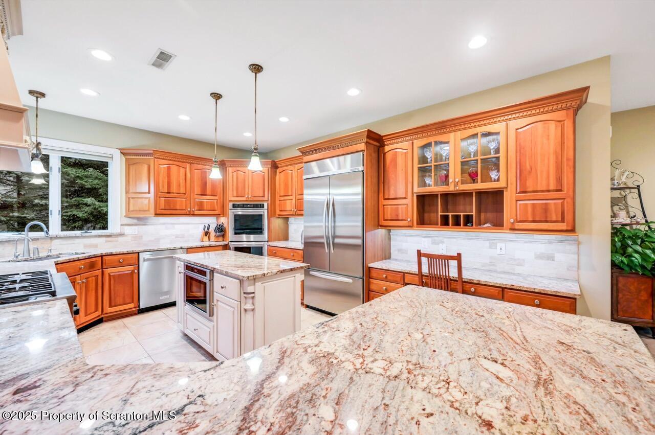 922 Old Logger Road Moscow, PA 18444 - Photo 24 of 93 a kitchen with stainless steel appliances granite countertop a stove and more cabinets