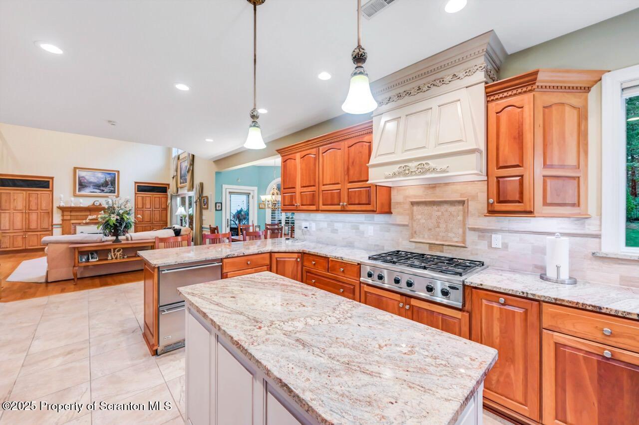 922 Old Logger Road Moscow, PA 18444 - Photo 26 of 93 a kitchen with stainless steel appliances granite countertop a stove a sink dishwasher and cabinets with wooden floor